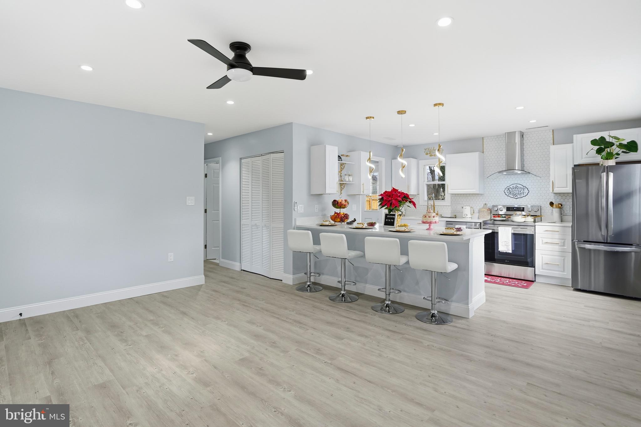 605 Sequoia Drive Edgewood, MD 21040 - Photo 7 of 28 a living room with stainless steel appliances kitchen island furniture and wooden floor