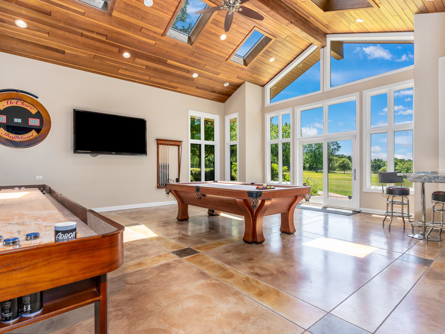 12 Arrowhead Lane DeKalb, IL 60115 - Photo 25 of 55 a living room with furniture a flat screen tv and a floor to ceiling window