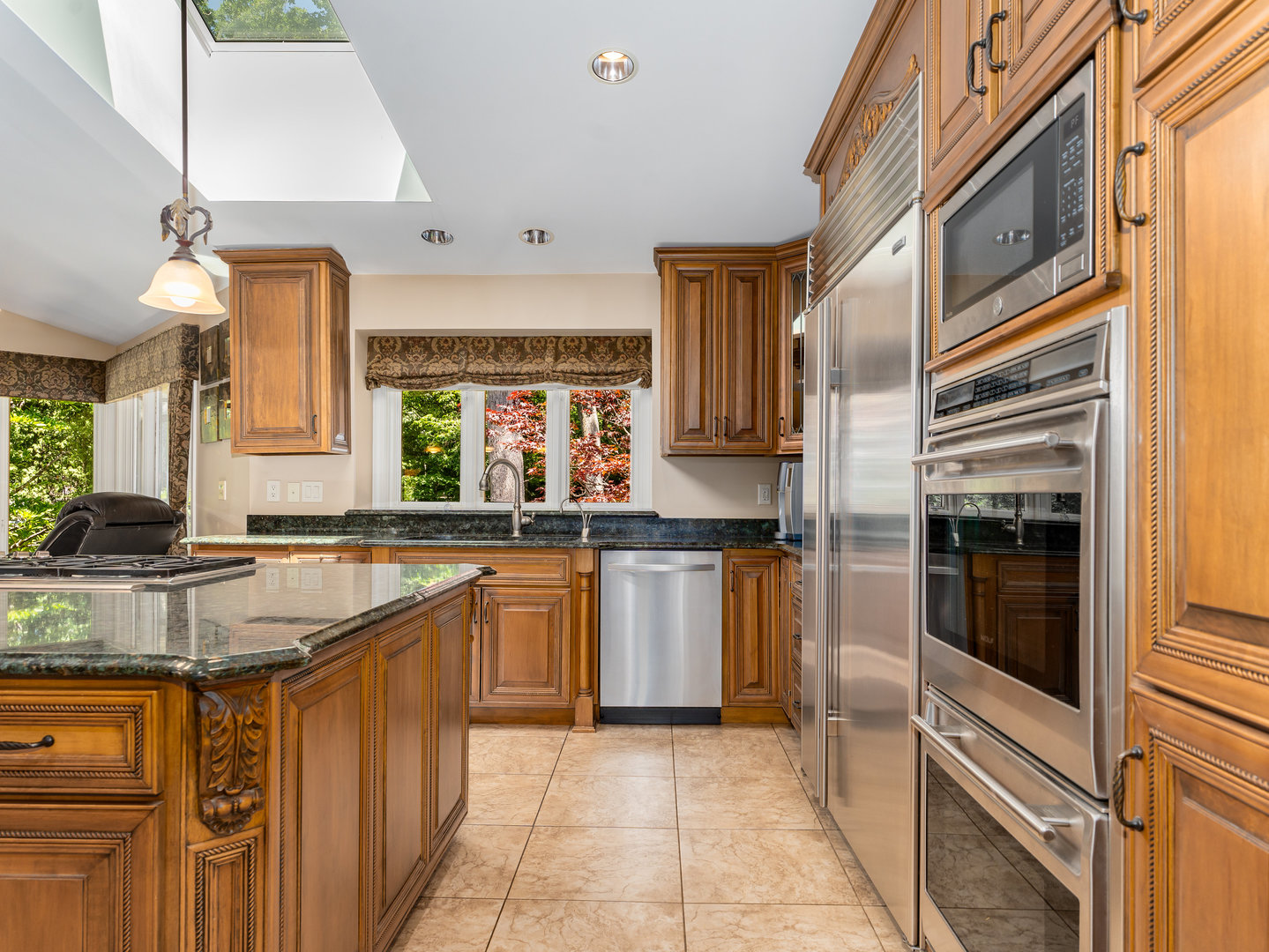 12 Arrowhead Lane DeKalb, IL 60115 - Photo 10 of 55 a kitchen with stainless steel appliances granite countertop a sink and cabinets