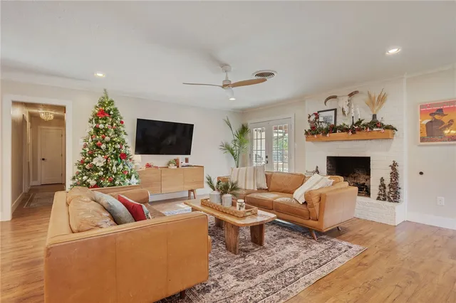 a living room with furniture a flat screen tv and a fireplace