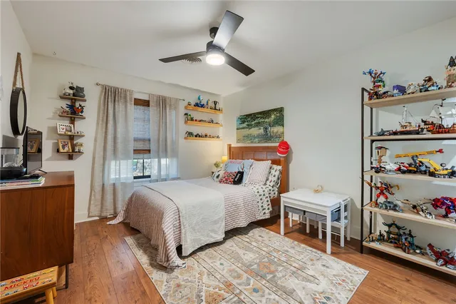 a bedroom with furniture and a wooden floor