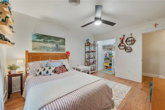 a bedroom with a bed and a book shelf