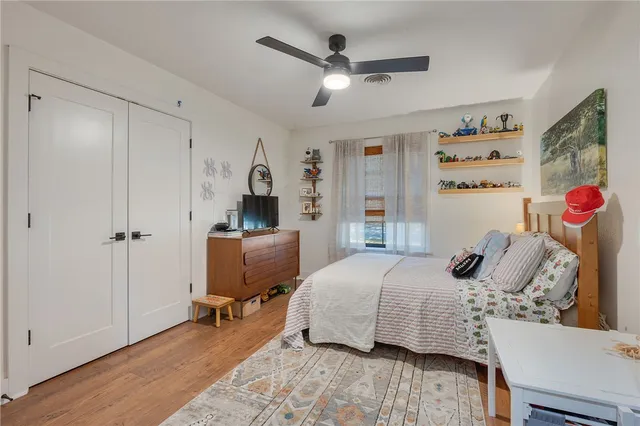 a bedroom with a bed and wooden floor