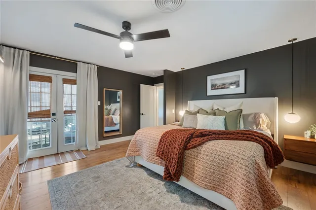 a spacious bedroom with a large bed and a chandelier