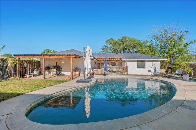 a swimming pool with outdoor seating yard and barbeque oven