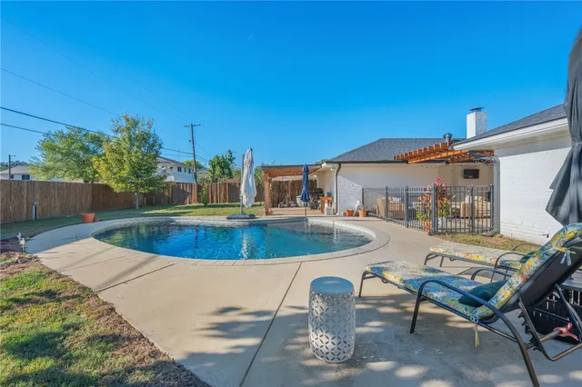 a view of a swimming pool with chairs
