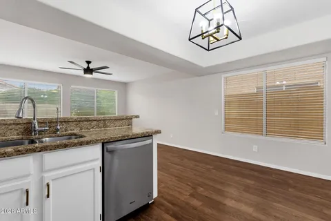 a kitchen with a sink cabinets and window