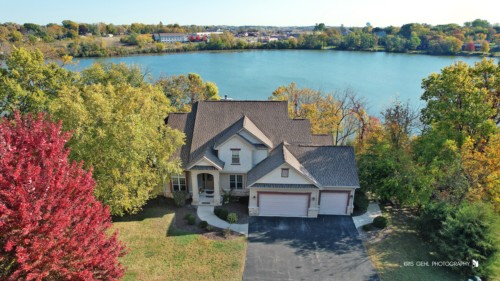 an aerial view of a house with a lake view