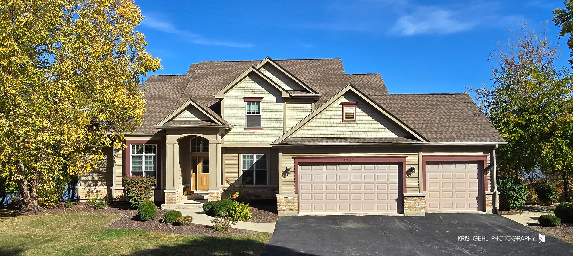 1265 Bayshore Drive Antioch, IL 60002 - Photo 2 of 42 a front view of a house with a yard and garage
