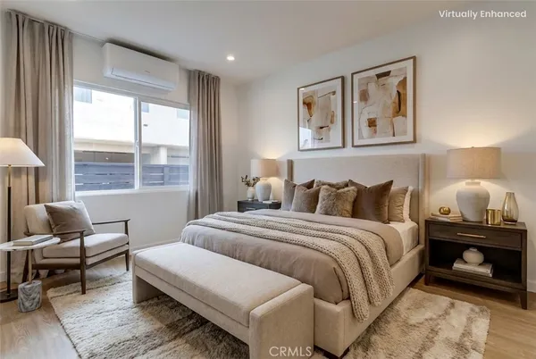 a bedroom with bed and a large window