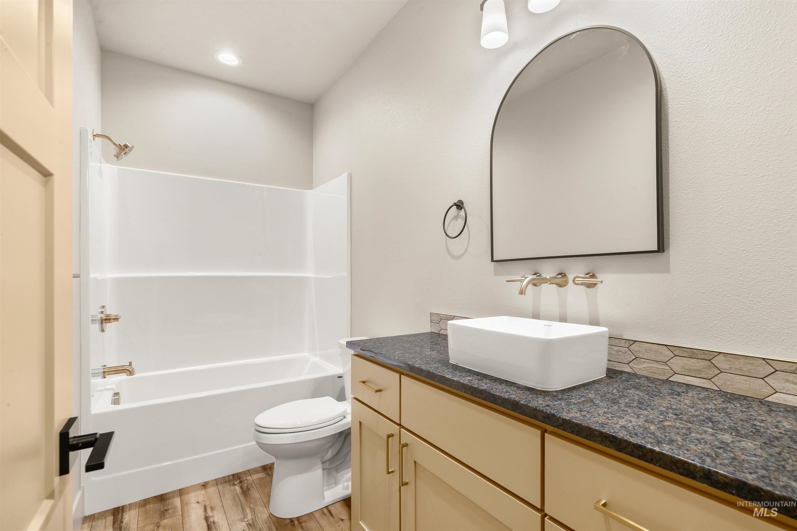 335 Warner Avenue Lewiston, ID 83501 - Photo 37 of 43 Full bath with vanity, light wood finished floors, and tub / shower combination