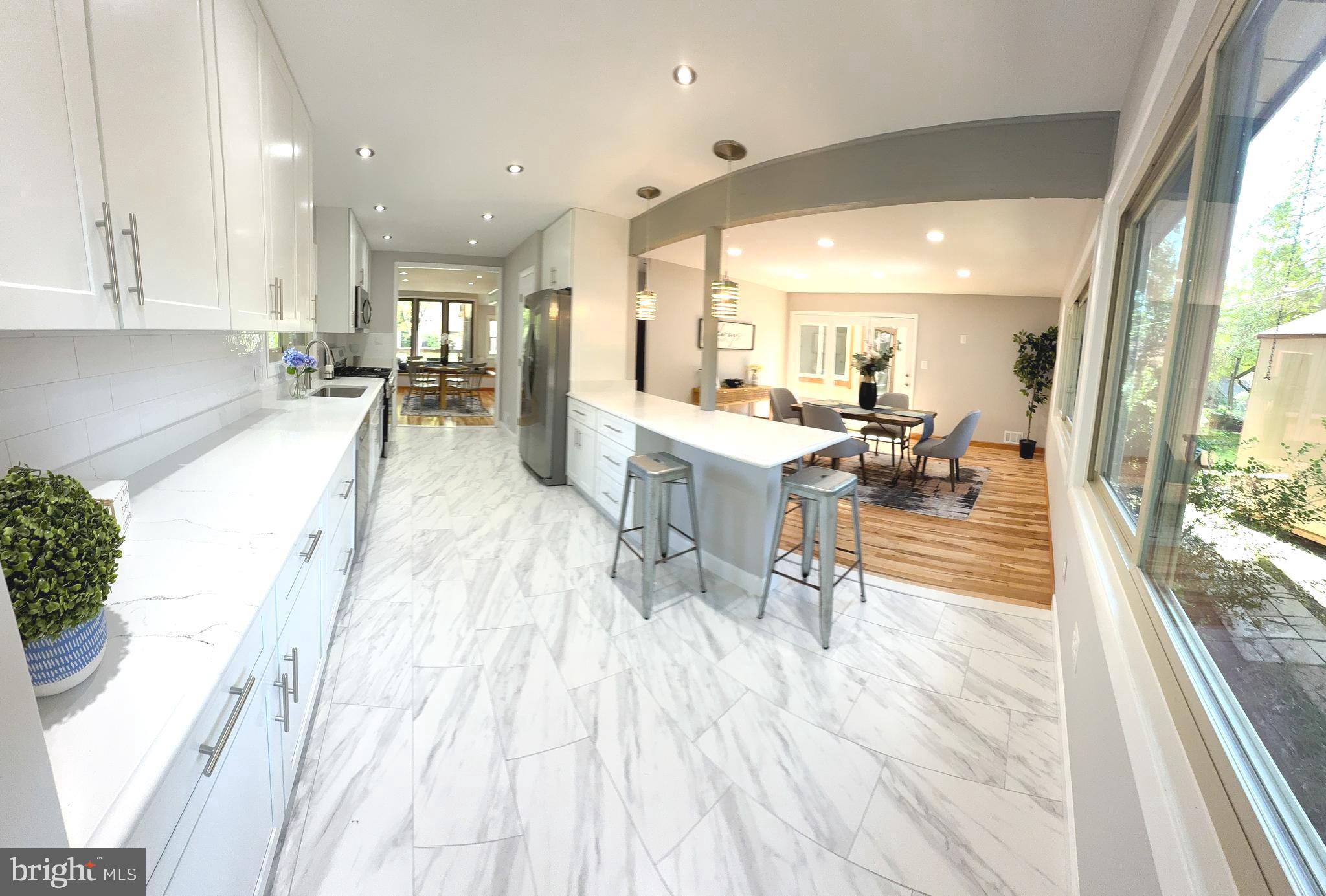 10601 Fiesta Road Fairfax, VA 22032 - Photo 11 of 58 a dining hall with stainless steel appliances furniture dining table and wooden floor