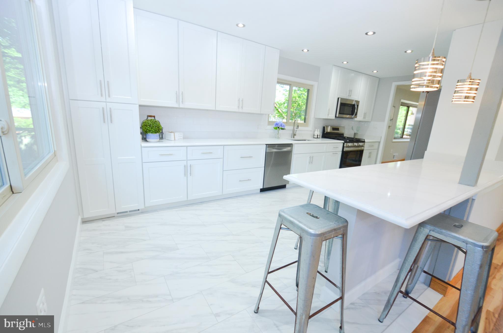 10601 Fiesta Road Fairfax, VA 22032 - Photo 13 of 58 a kitchen with white cabinets and appliances