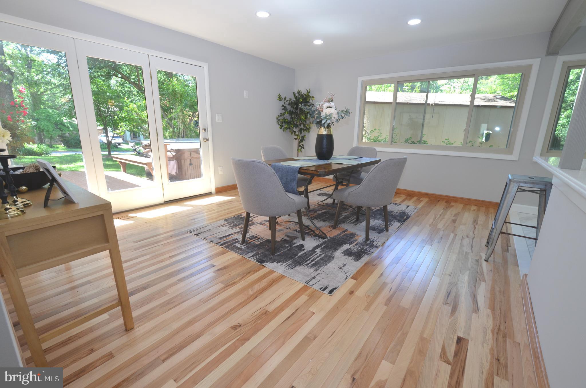 10601 Fiesta Road Fairfax, VA 22032 - Photo 19 of 58 a workspace with wooden floor and a floor to ceiling window