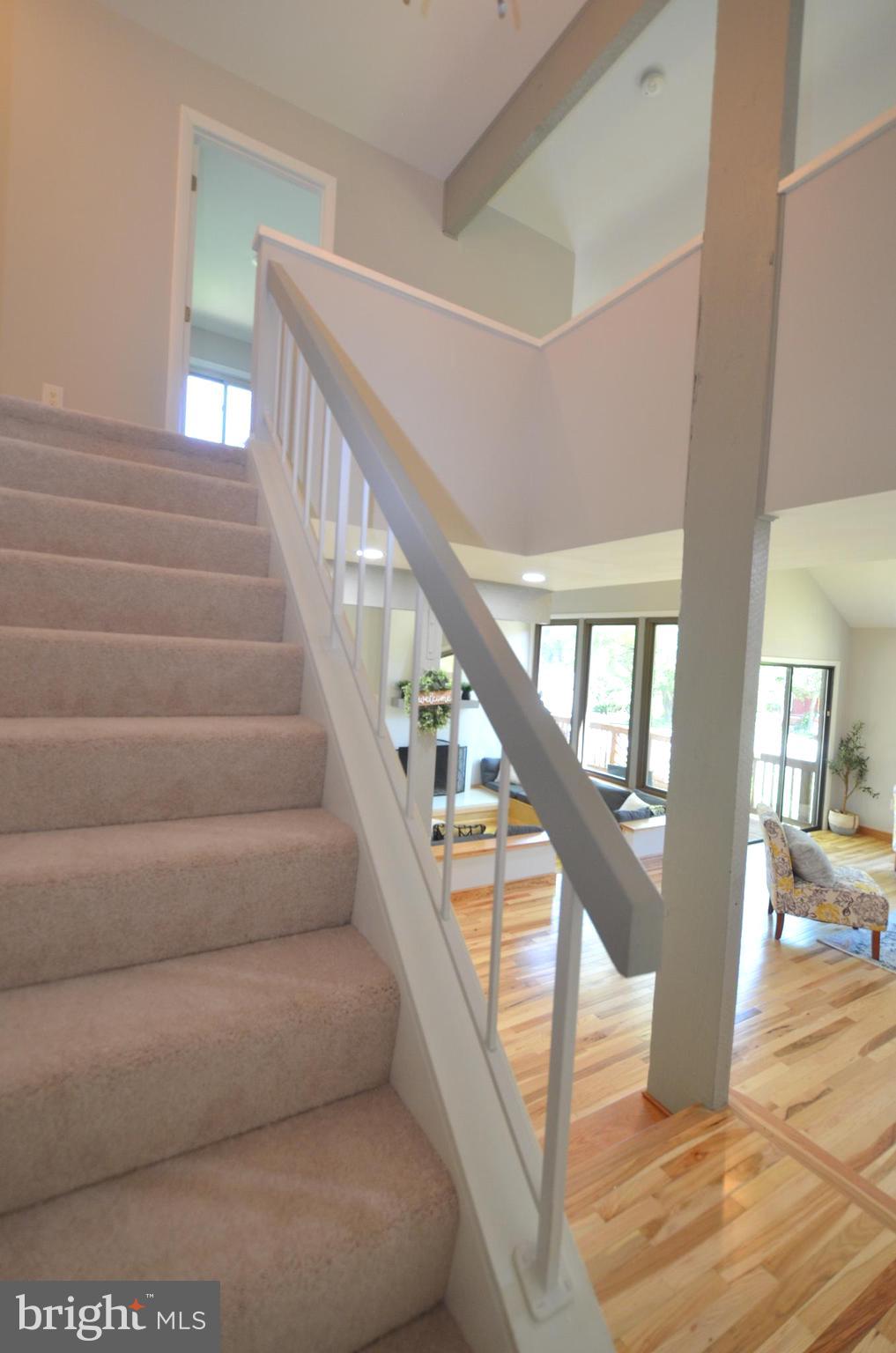 10601 Fiesta Road Fairfax, VA 22032 - Photo 31 of 58 a view of staircase with lots of frames on wall and wooden floor