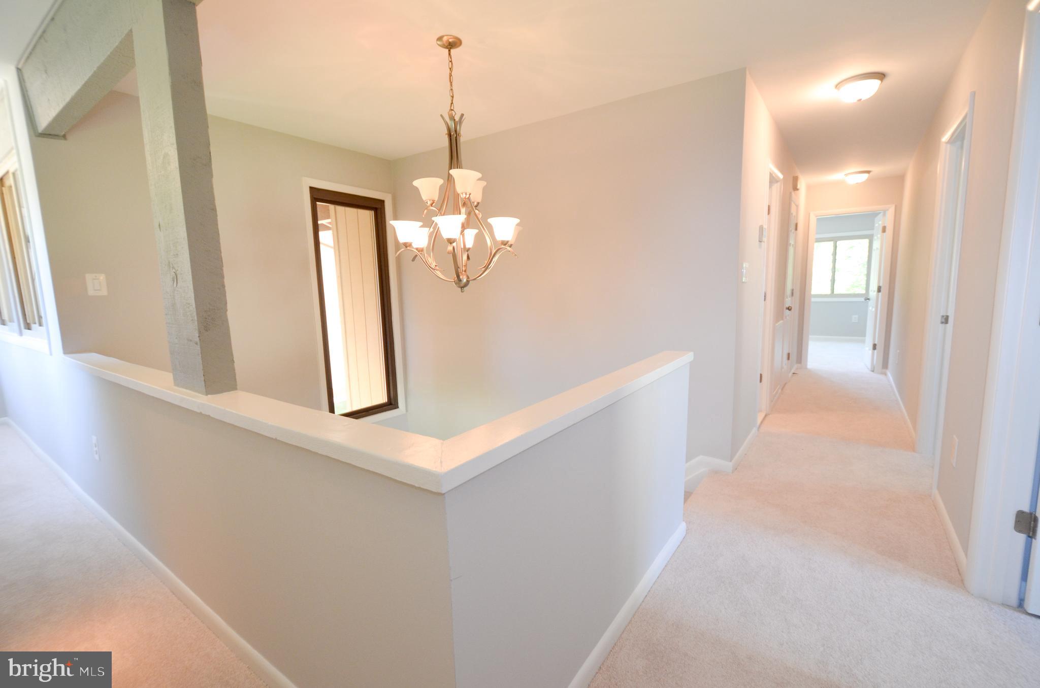 10601 Fiesta Road Fairfax, VA 22032 - Photo 32 of 58 a view of a hallway with a chandelier