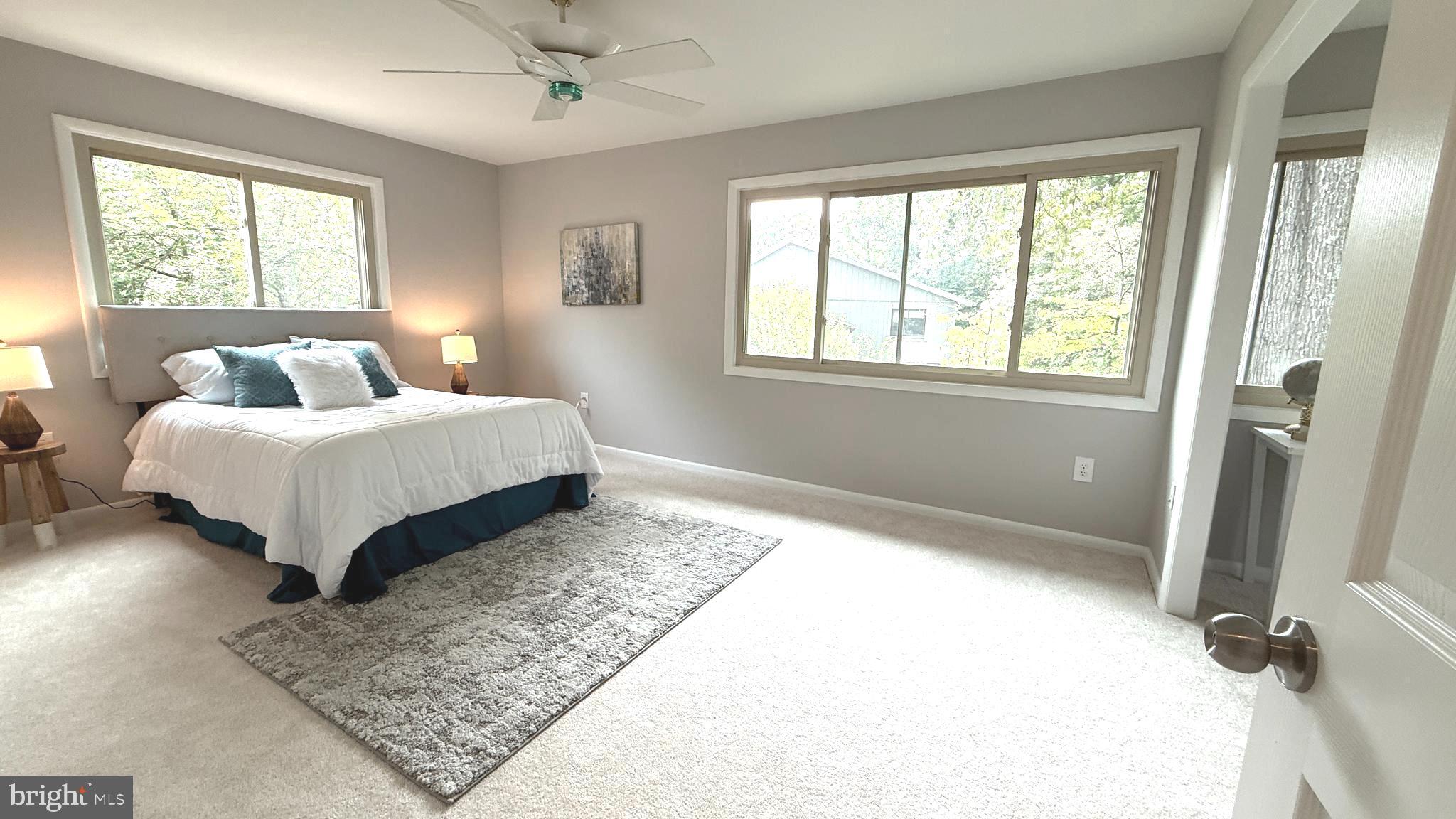 10601 Fiesta Road Fairfax, VA 22032 - Photo 41 of 58 a bedroom with a bed lamp and a large window