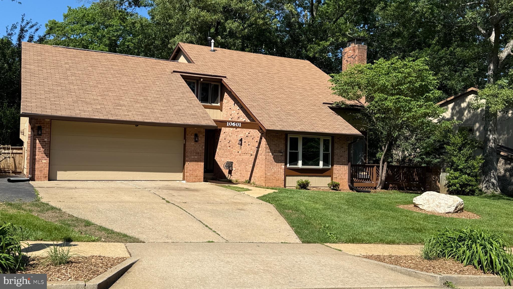 10601 Fiesta Road Fairfax, VA 22032 - Photo 55 of 58 a front view of a house with a yard and garage