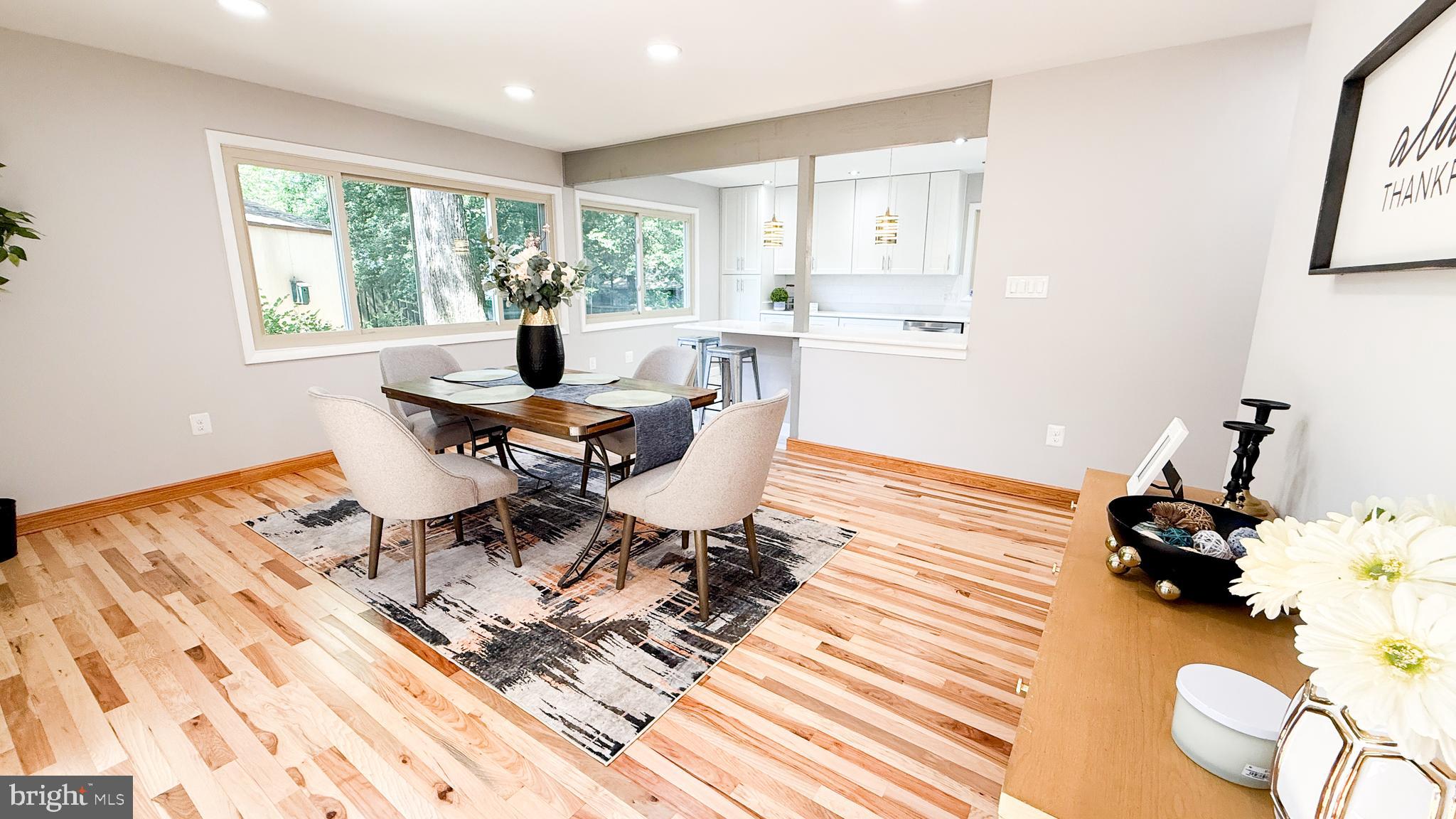10601 Fiesta Road Fairfax, VA 22032 - Photo 7 of 58 a living room with a large window wooden floor and furniture