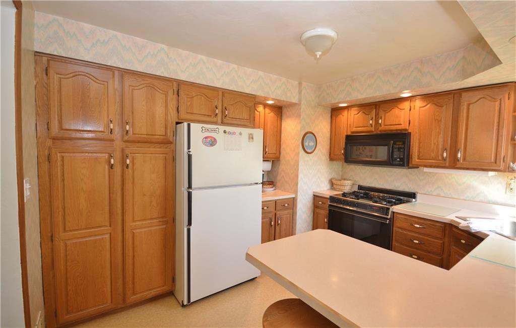 296 Ewings Mill Road Coraopolis, PA 15108 - Photo 6 of 19 Kitchen is outfitted with spacious pantry which features roll-out shelves for tons of storage and convenience.