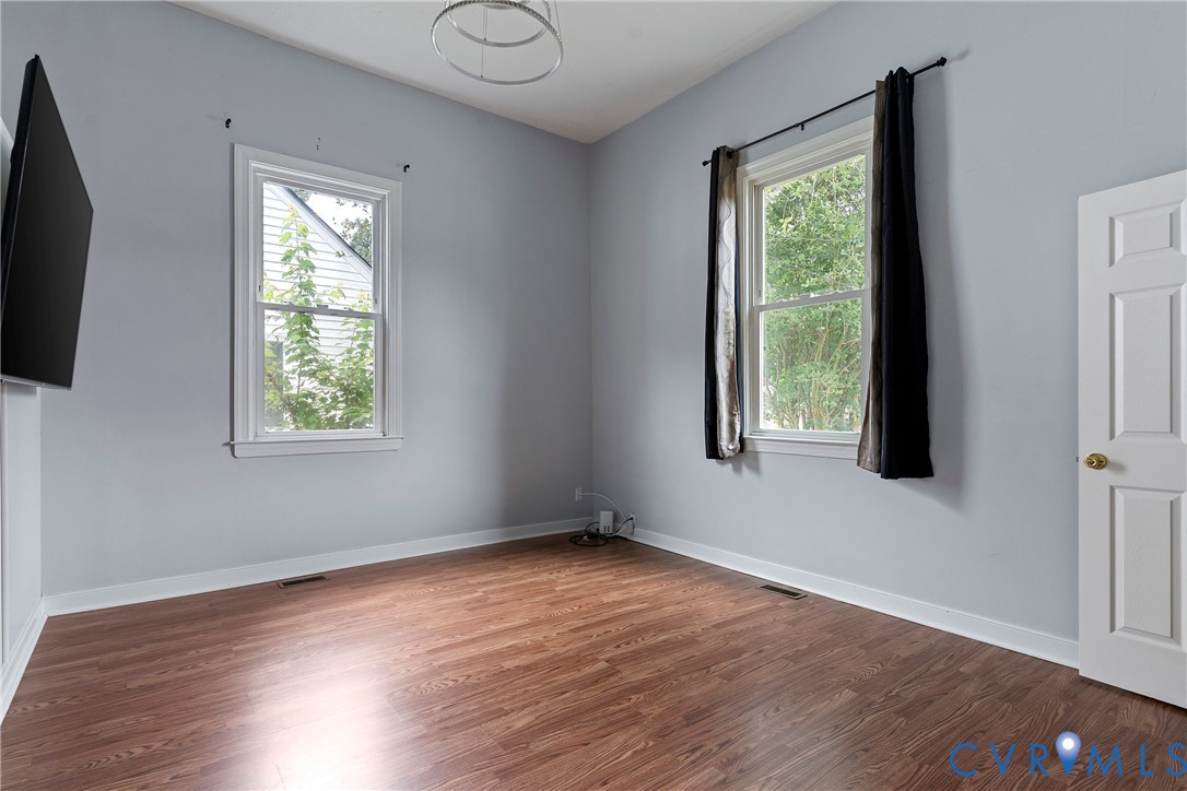 166 Wright Avenue Colonial Heights, VA 23834 - Photo 13 of 36 an empty room with wooden floor and windows