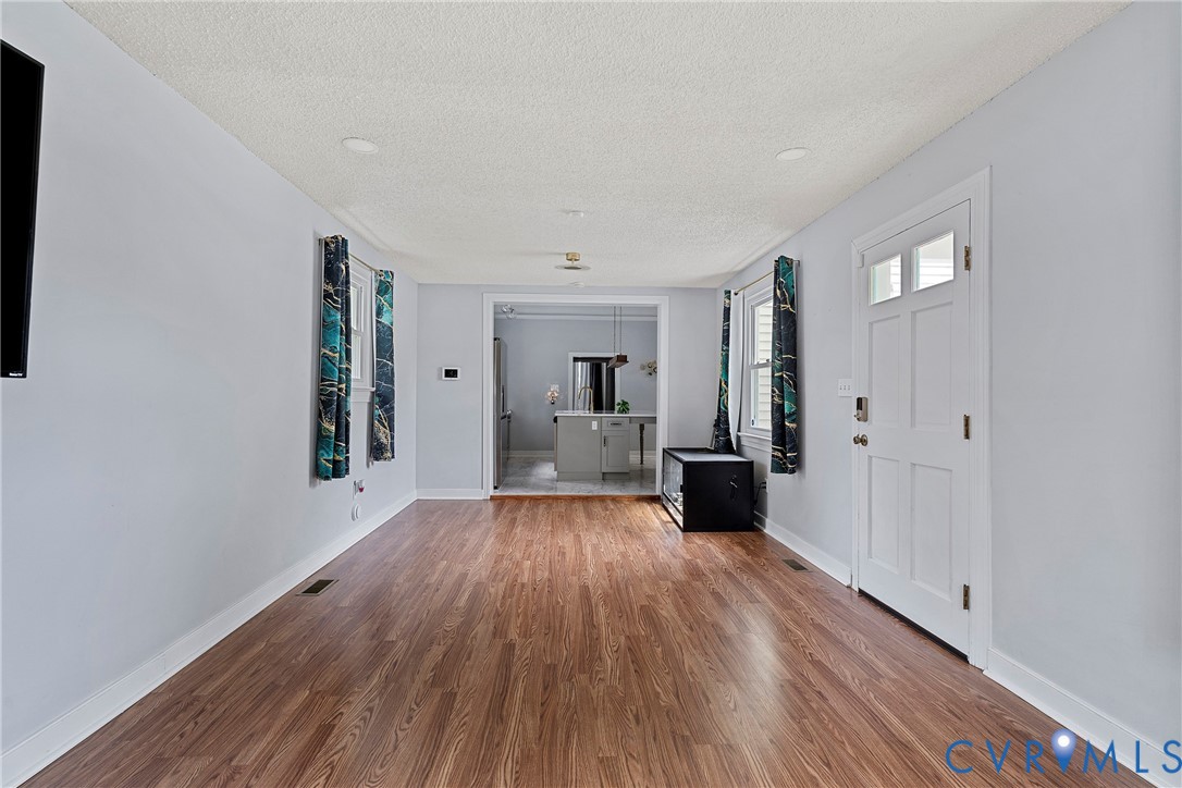 166 Wright Avenue Colonial Heights, VA 23834 - Photo 6 of 36 a view of a big room with wooden floor and windows