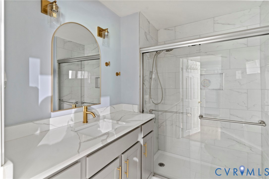 166 Wright Avenue Colonial Heights, VA 23834 - Photo 10 of 36 a bathroom with a granite countertop sink a mirror and shower