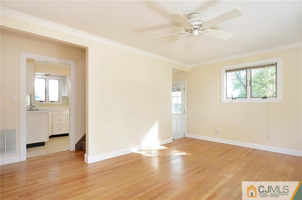 77 South Pennington Road New Brunswick, NJ 08901 - Photo 3 of 18 an empty room with wooden floor and windows