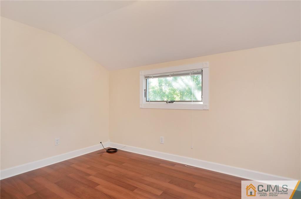 77 South Pennington Road New Brunswick, NJ 08901 - Photo 8 of 18 an empty room with wooden floor and windows