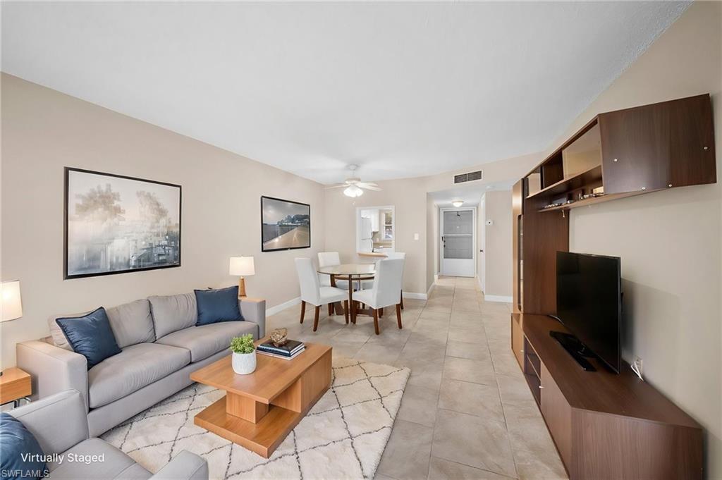 170 Turtle Lake Court, Unit 109 Naples, FL 34105 - Photo 3 of 19 Living area with a ceiling fan and light tile patterned floors
