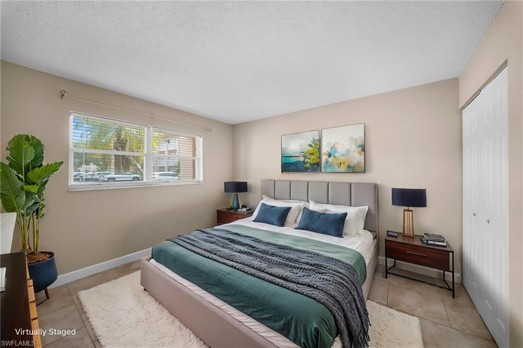 170 Turtle Lake Court, Unit 109 Naples, FL 34105 - Photo 6 of 19 Bedroom with a closet and light tile patterned floors