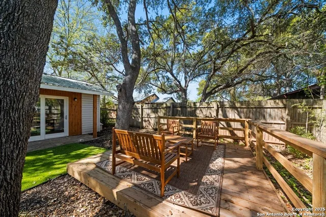 a view of a house with backyard and sitting area