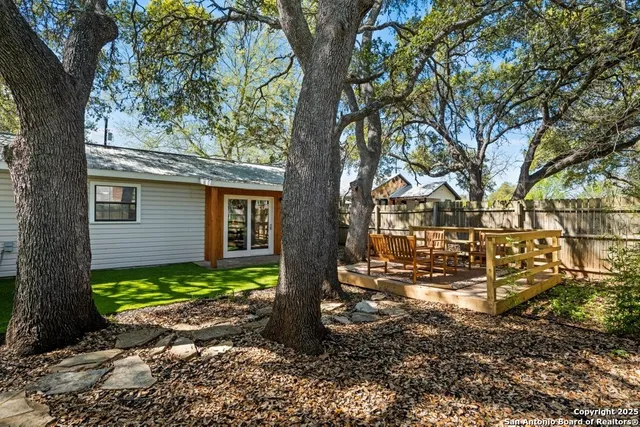 a view of a house with a tree in the yard