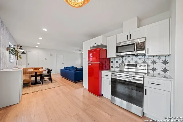 a kitchen with stainless steel appliances granite countertop a stove and a refrigerator