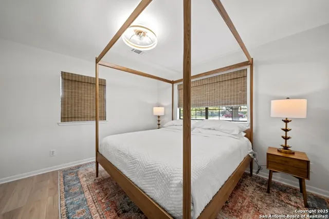 a bed sitting in a bedroom next to a window