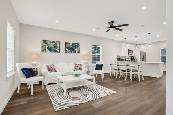 a living room with furniture a rug and a table