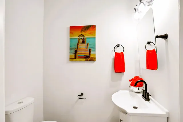 a bathroom with a sink mirror and vanity