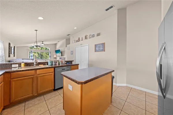 a kitchen with stainless steel appliances granite countertop a sink and a refrigerator