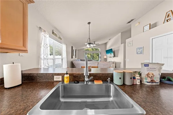 a kitchen with stainless steel appliances granite countertop a sink counter space cabinets and a window