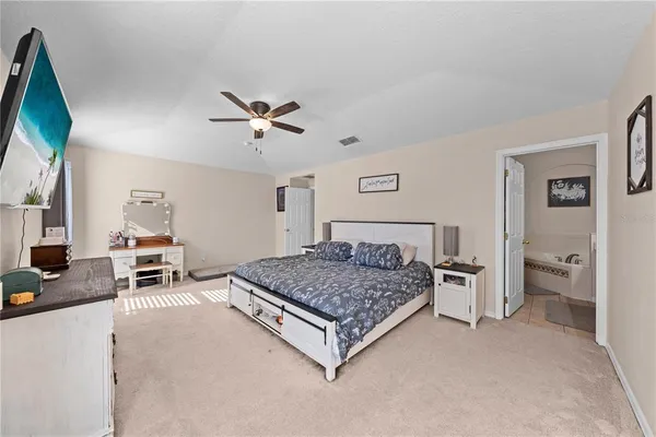 a bathroom with a tub a toilet and a shower