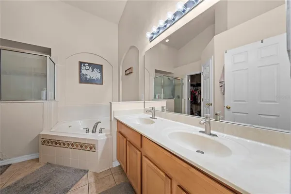 a view of walk in closet with clothes