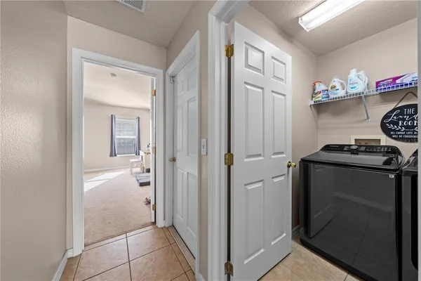 a white toilet sitting next to a white wall