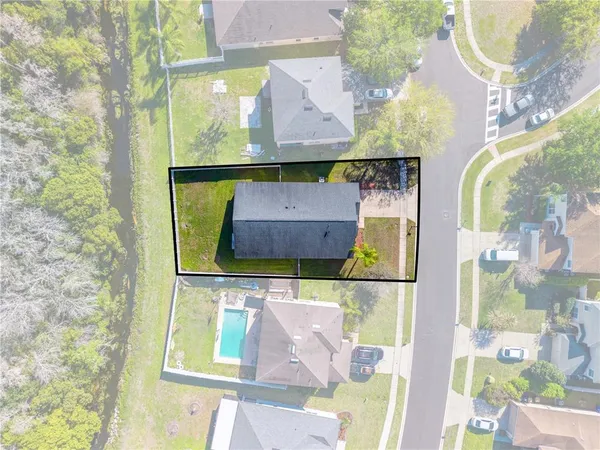 an aerial view of a house with a swimming pool yard and outdoor seating