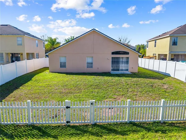 an aerial view of residential houses with outdoor space and seating