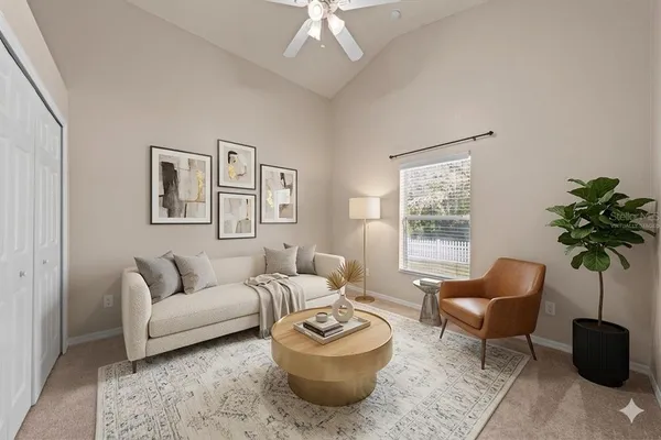 a living room with furniture and a potted plant