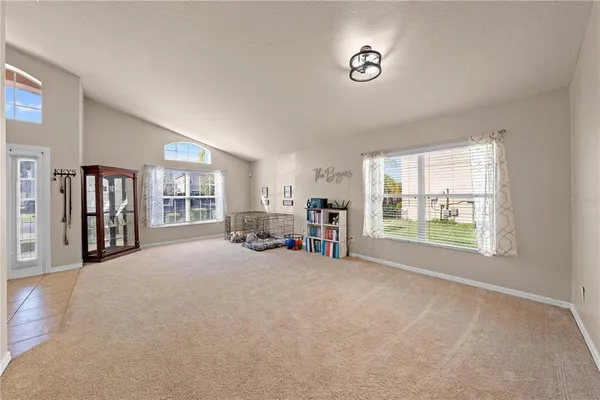 a view of a livingroom with a fireplace and window