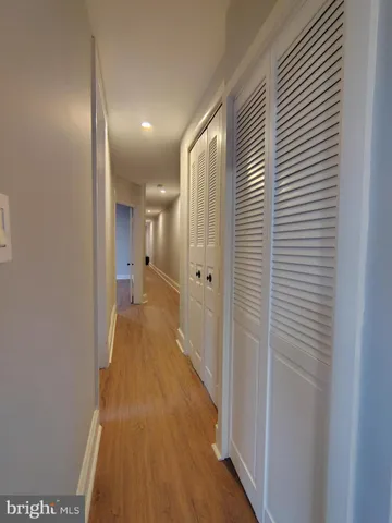 a view of a hallway with wooden floor