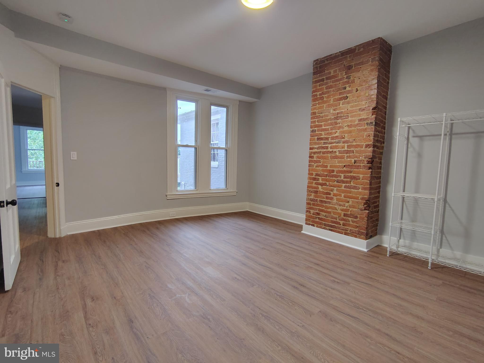 230 South Market Street, Unit 2 Frederick, MD 21701 - Photo 7 of 16 an empty room with wooden floor and windows