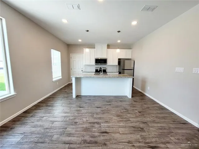 a view of a kitchen with microwave and cabinets