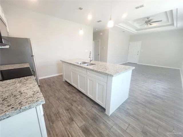 a kitchen with a sink and a stove top oven